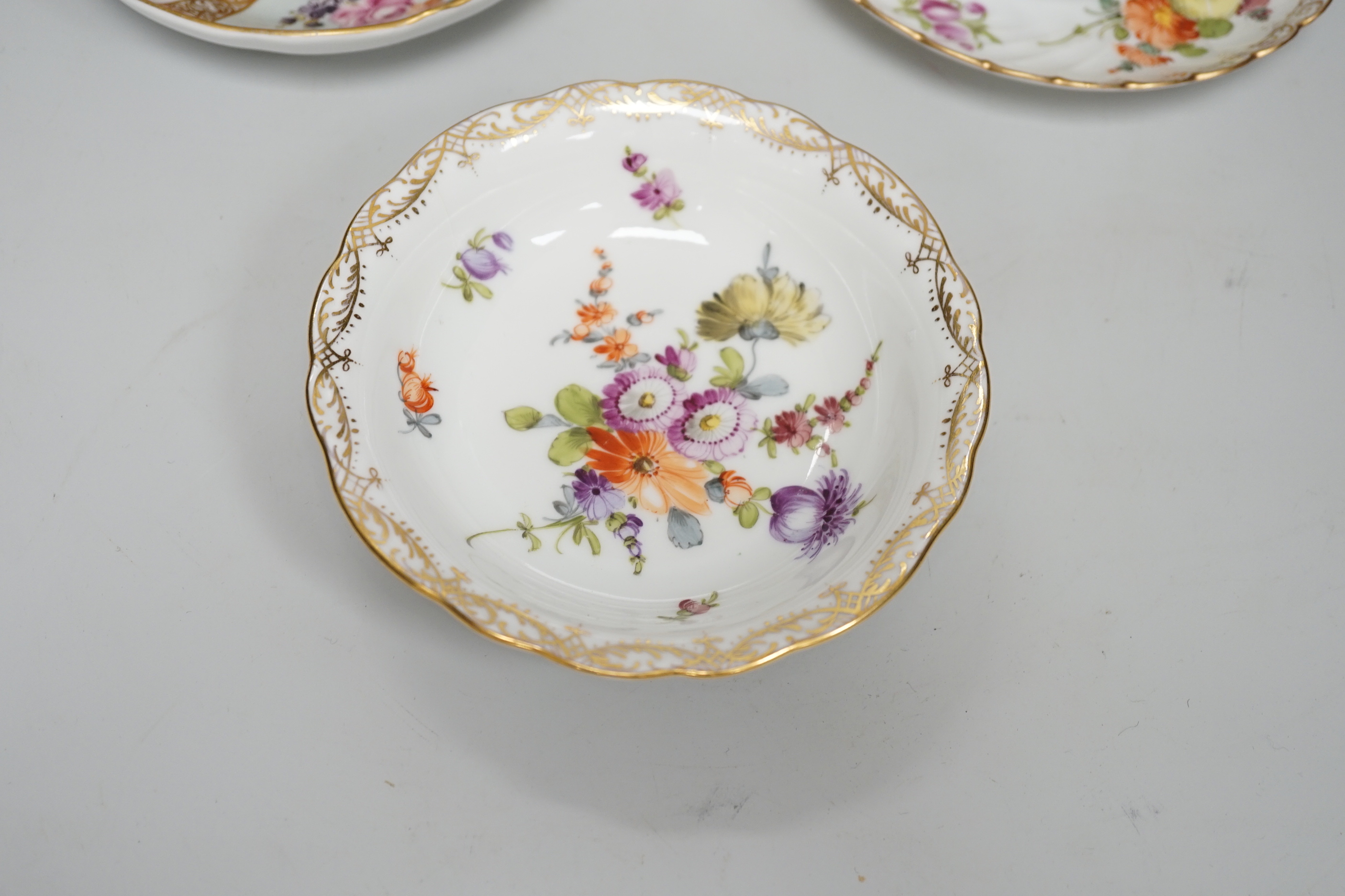 A Meissen style porcelain teacup and saucer together with a Dresden saucer and teacup and saucer